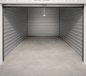 A closed metal garage door with a hanger in the middle.